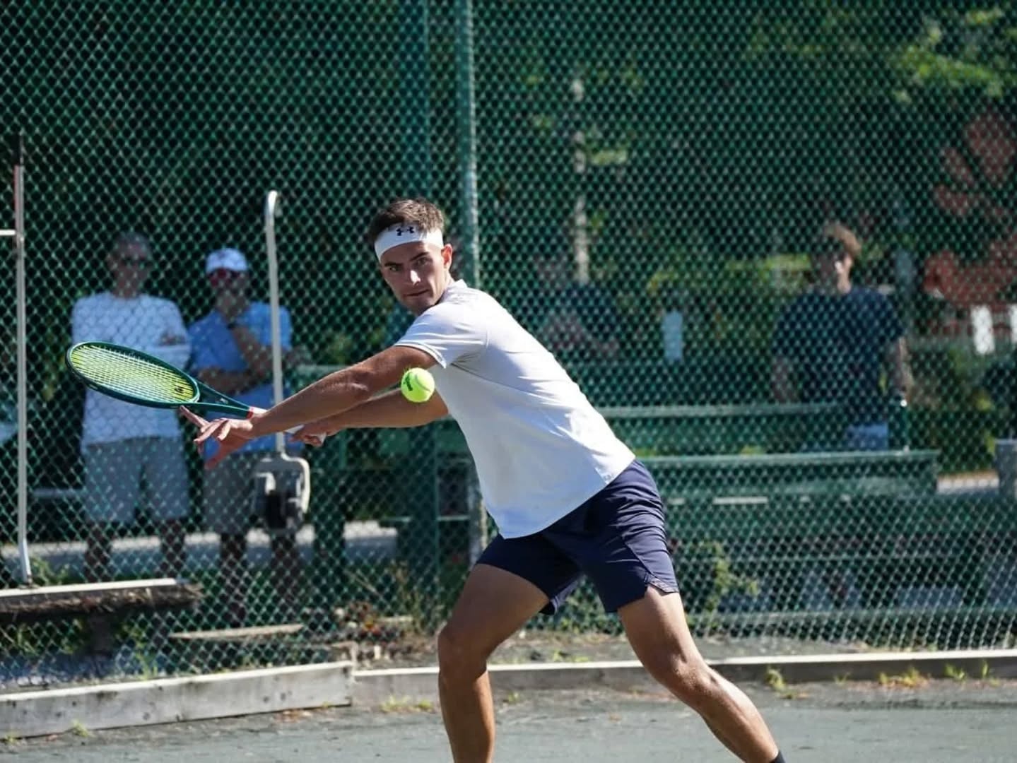 Cade Nadeau hitting a backhand during a competitive match
